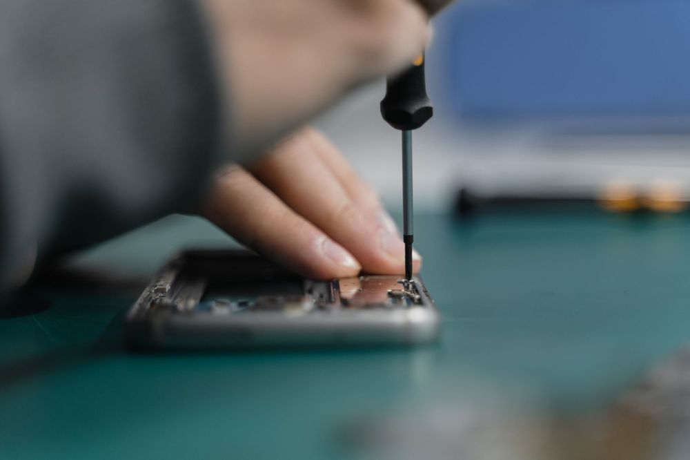 Tecnico che ripara uno smartphone in un laboratorio